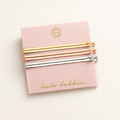 Six metallic hair bobbies in gold, rose gold and rhodium finishes on their pink card