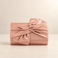 Studio presentation of the champagne bow evening clutch; original supplier photographs also available
